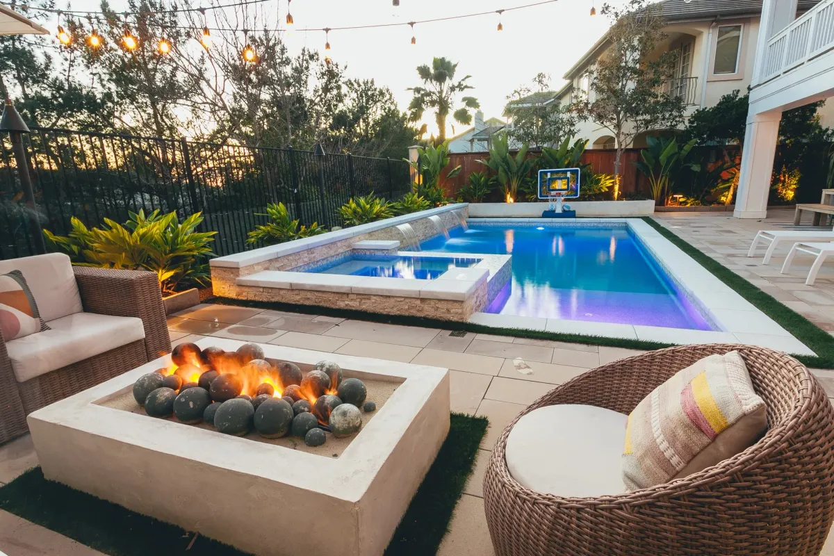 Beautiful custom modern pool with fire pit view Beautiful custom modern pool with fire pit view