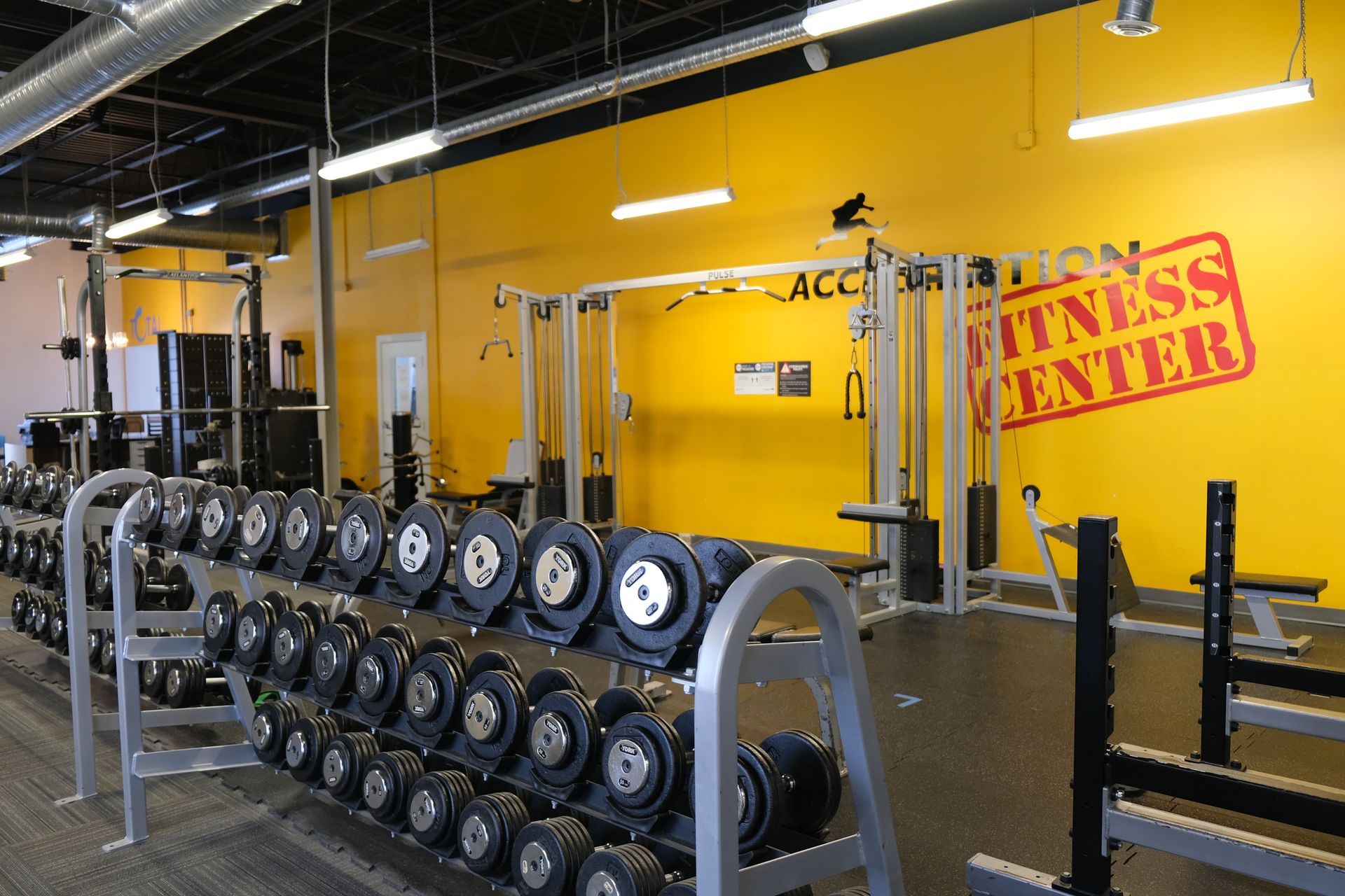 A gym with a sign that says fitness center
