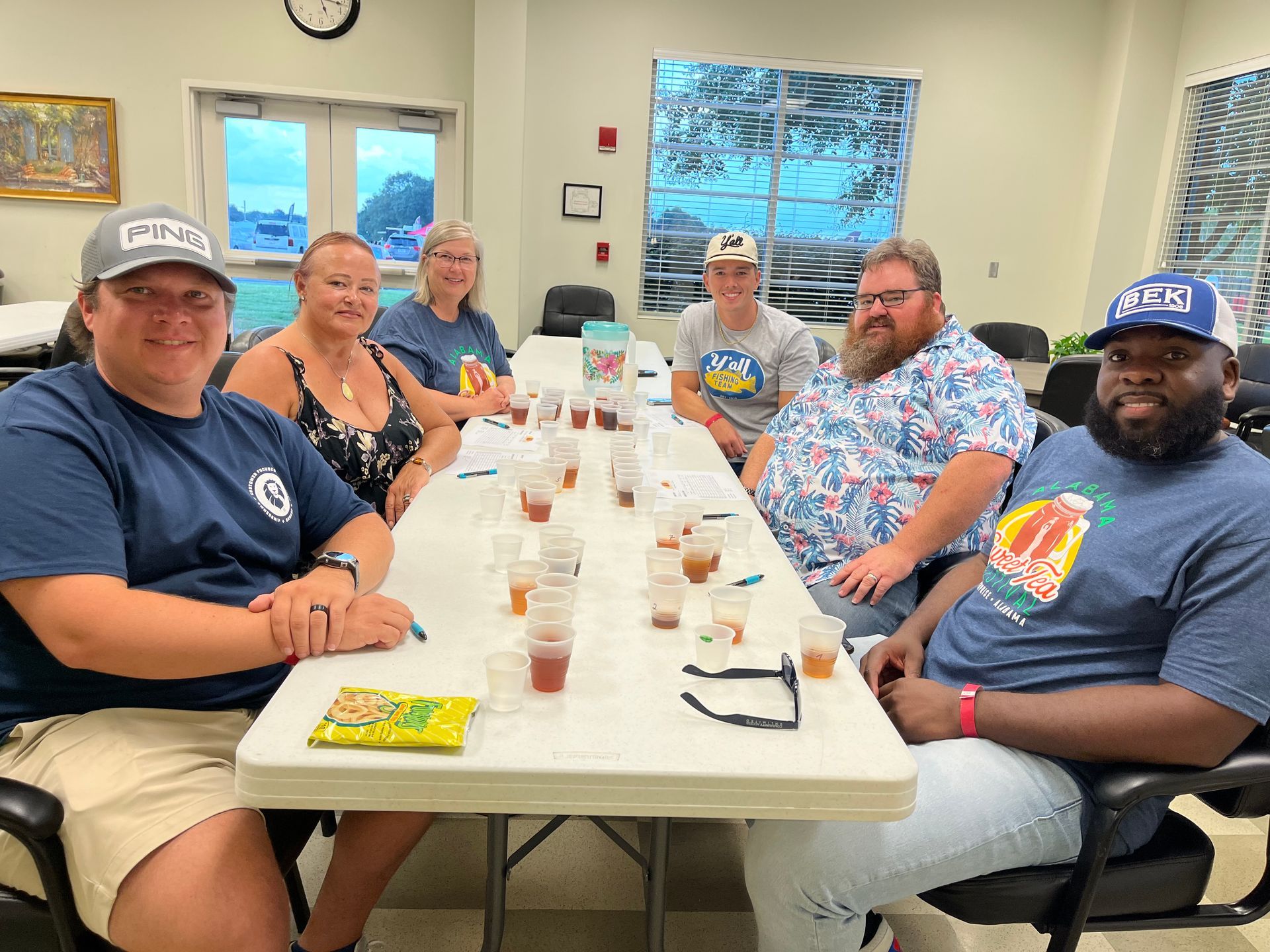 A group of people are sitting at a long table.