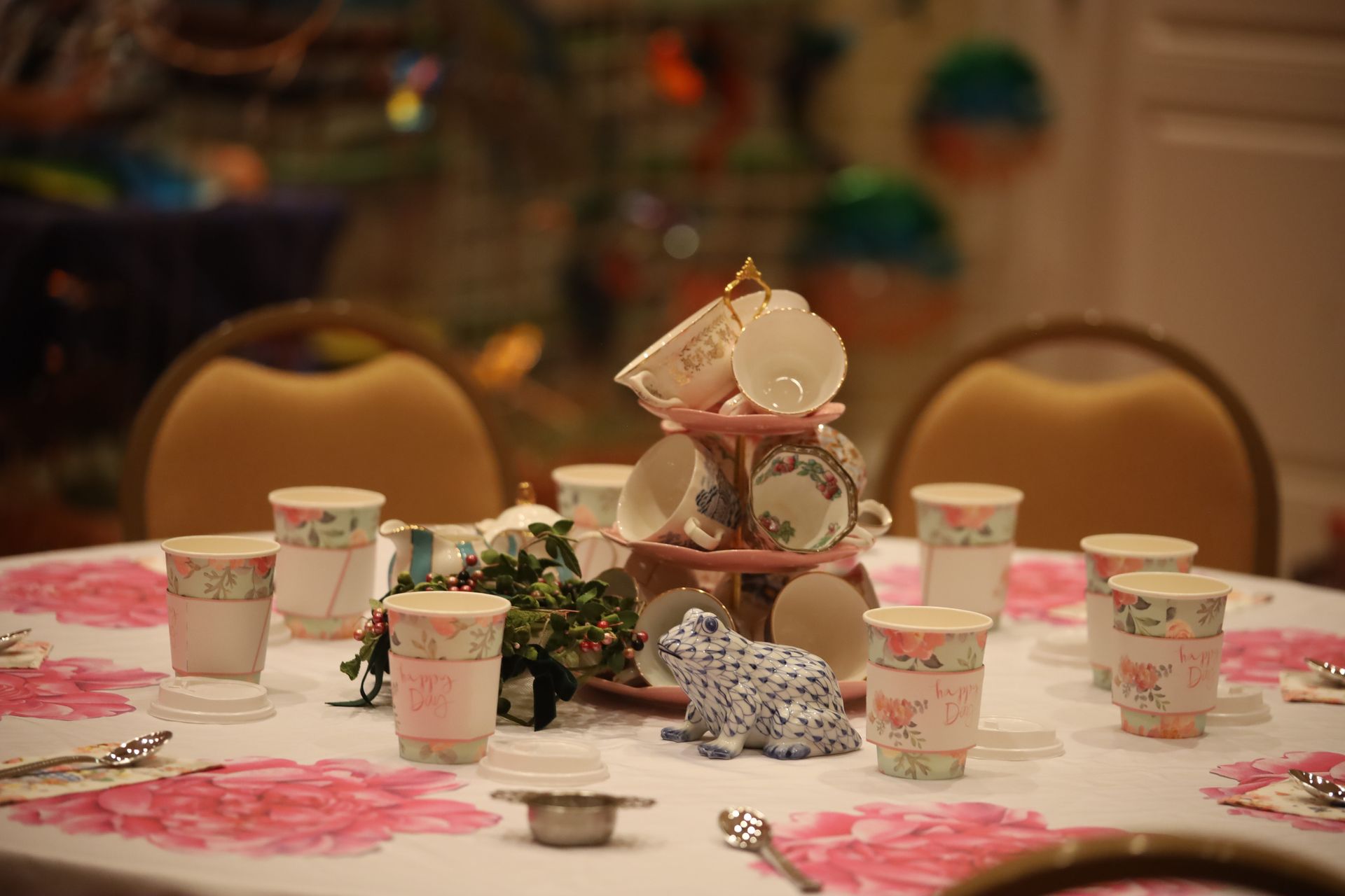 A table set for a tea party with cups and saucers on it