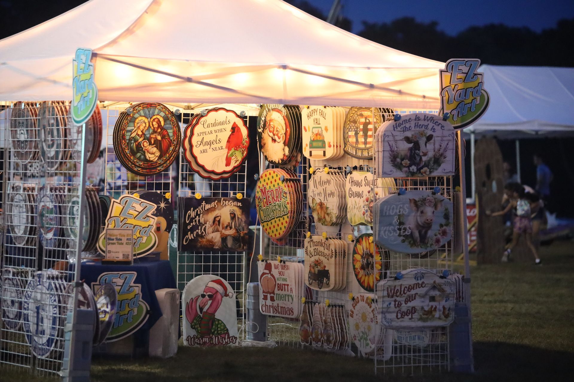 A tent with a lot of signs on it including one that says ' i love you '