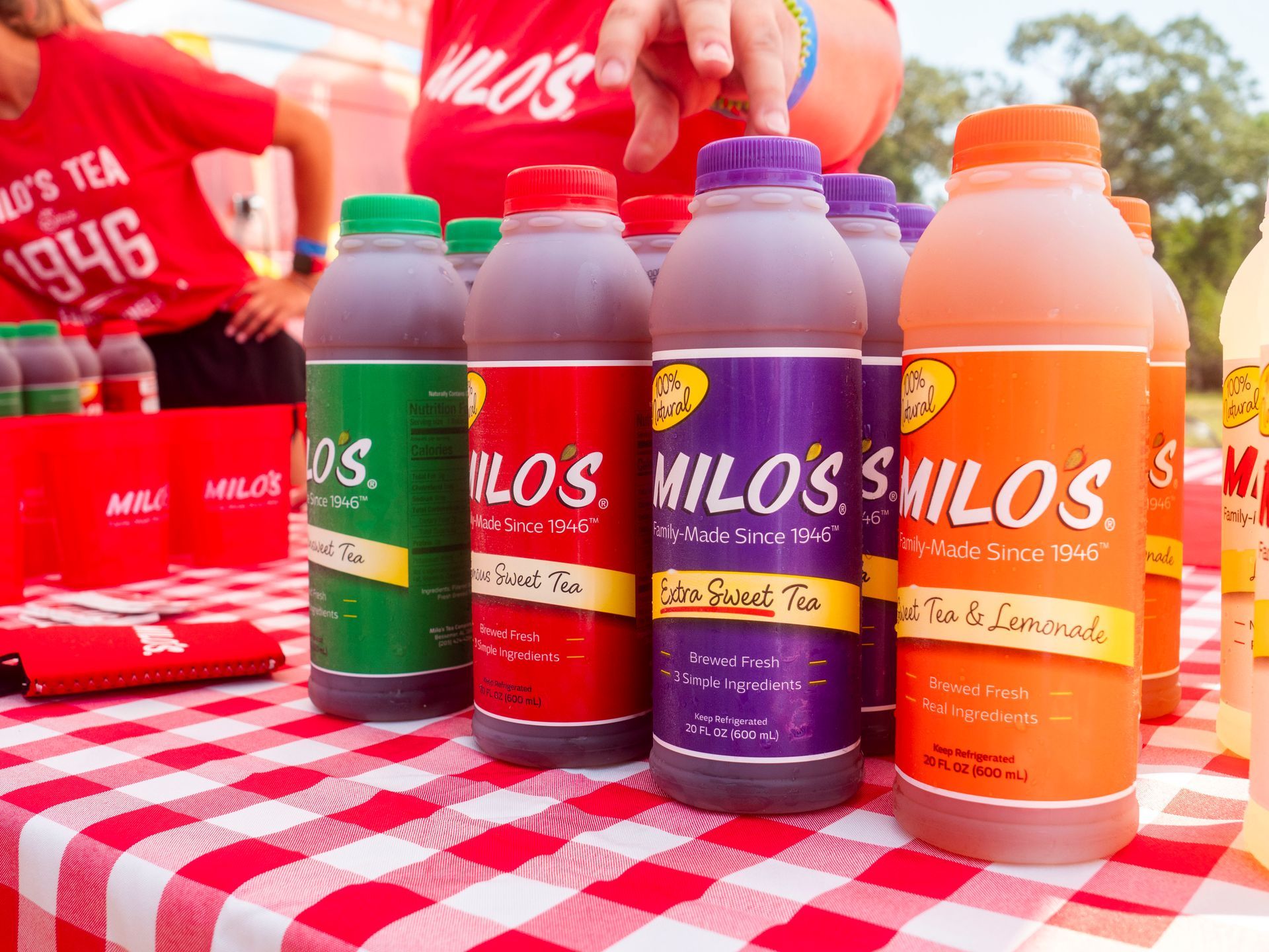 A table with bottles of milos tea on it