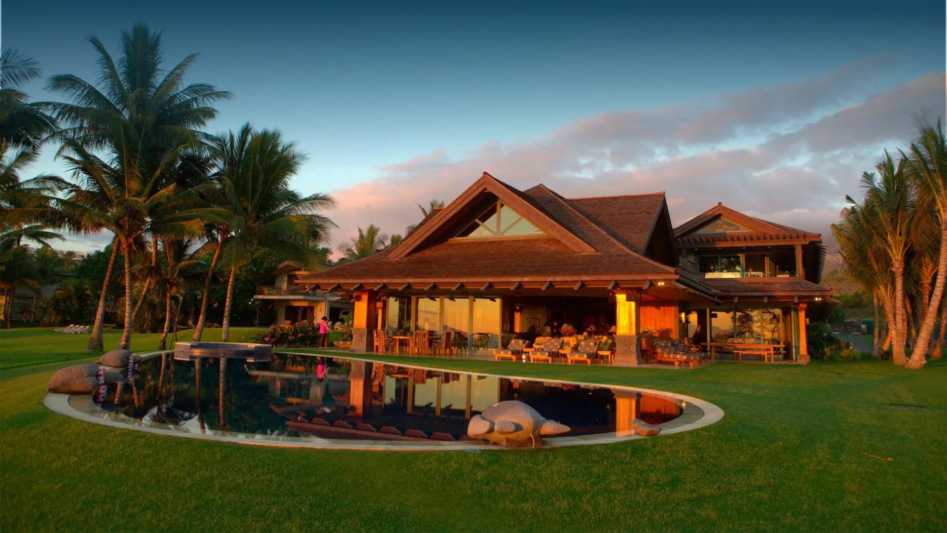A large house with a swimming pool in front of it