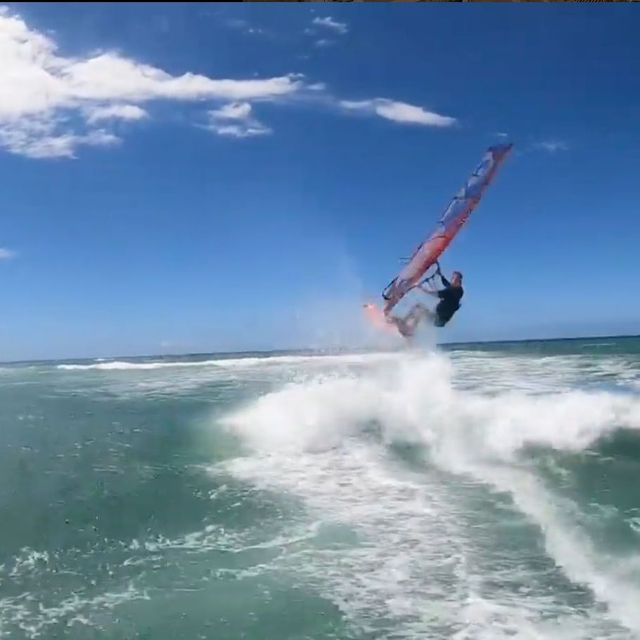 Ryan Levis is wind surfing on the ocean