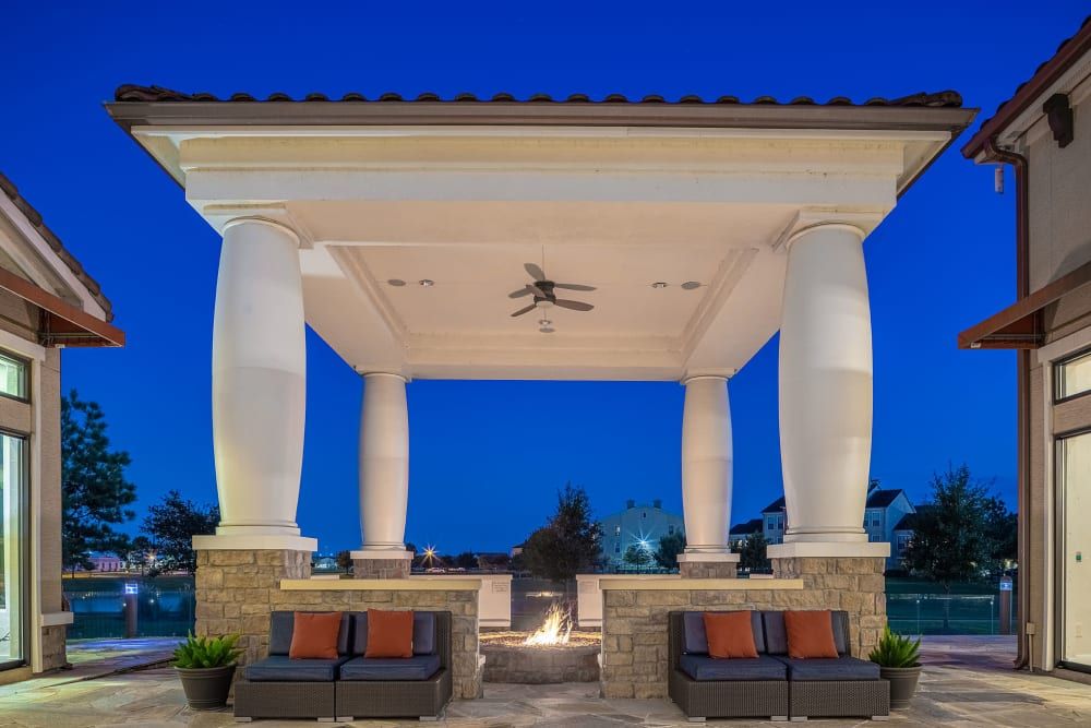 A gazebo with a fire pit in the middle of it at Marquis at the Reserve in Katy, TX.