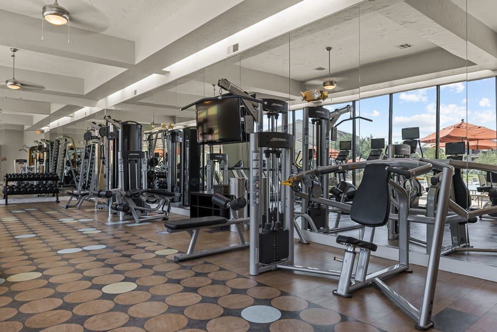 A large gym filled with lots of exercise equipment at Marquis at the Reserve in Katy, TX.