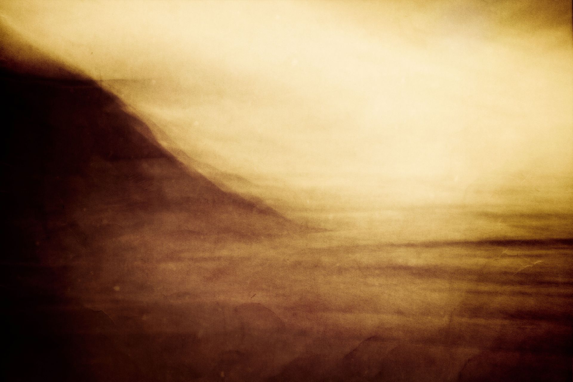 Dreamy sepia photo of an ocean mountain landscape