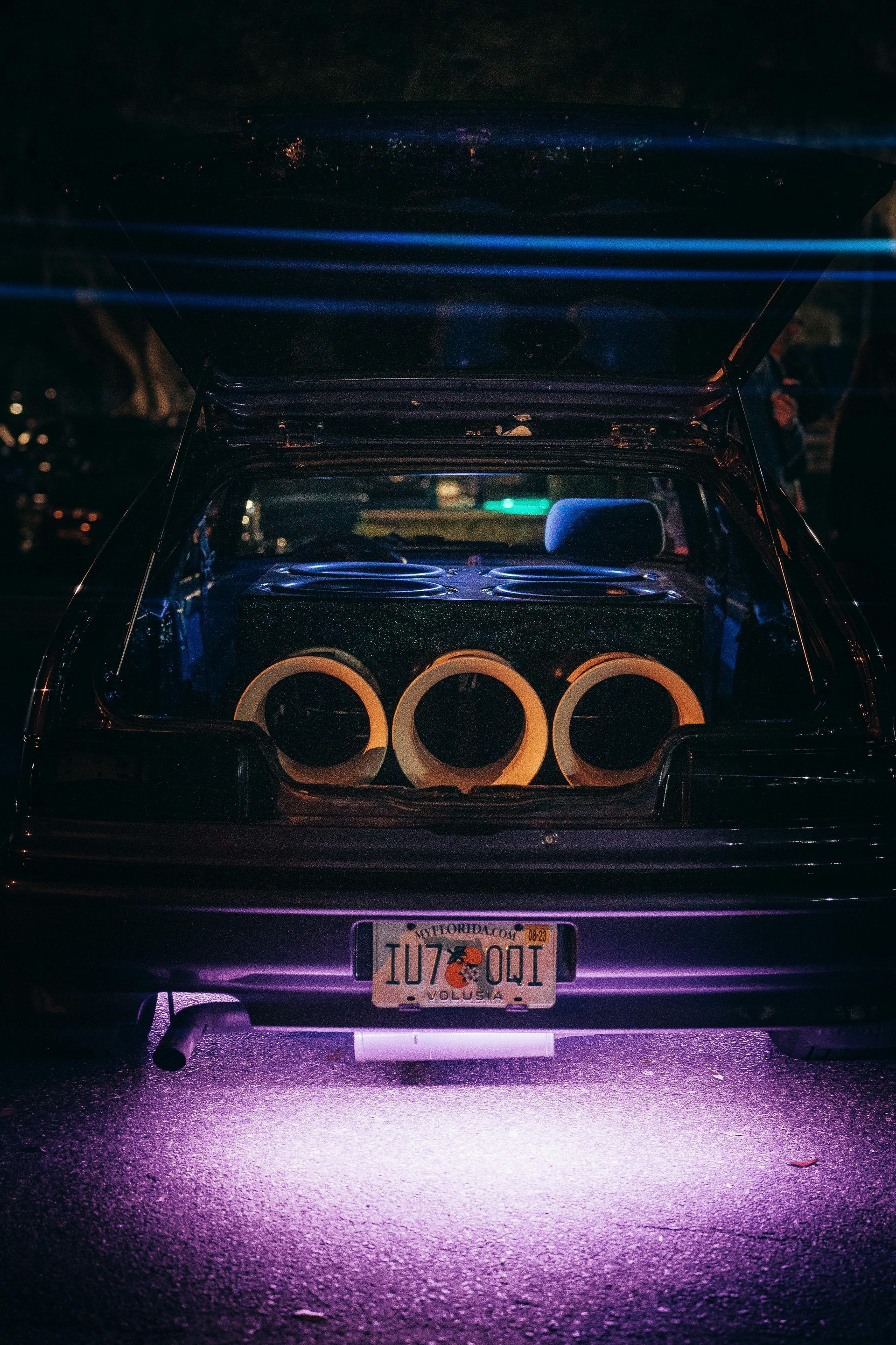 Professional subwoofer installation with custom enclosure and accent lighting