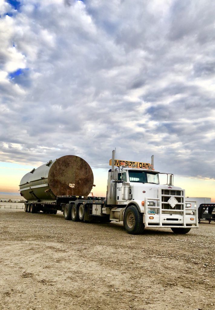 semi carrying a large oil tank