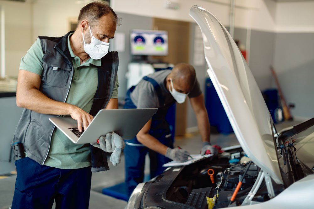 Mechanic Working On Computer — Columbus, NJ — A1 Auto & Truck Repair Inc Mechanic Working On Computer — Columbus, NJ — A1 Auto & Truck Repair Inc