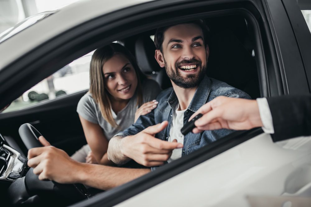 A Man and A Woman Are Sitting in A Car . the Man Is Holding a Car Key — Start Learning Automotive in Sunshine Coast, QLD