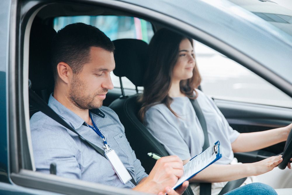 A Man Is Teaching a Woman how To Drive a Car — Start Learning Automotive in Sydney, NSW