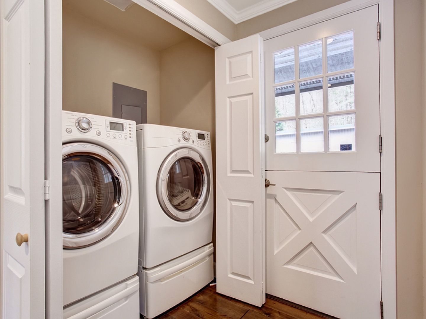 Laundry room with white washer and dryer, and a Dutch door.