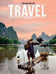 Travel magazine cover showing a person poling a boat on a misty river at sunrise, with cliffs and birds