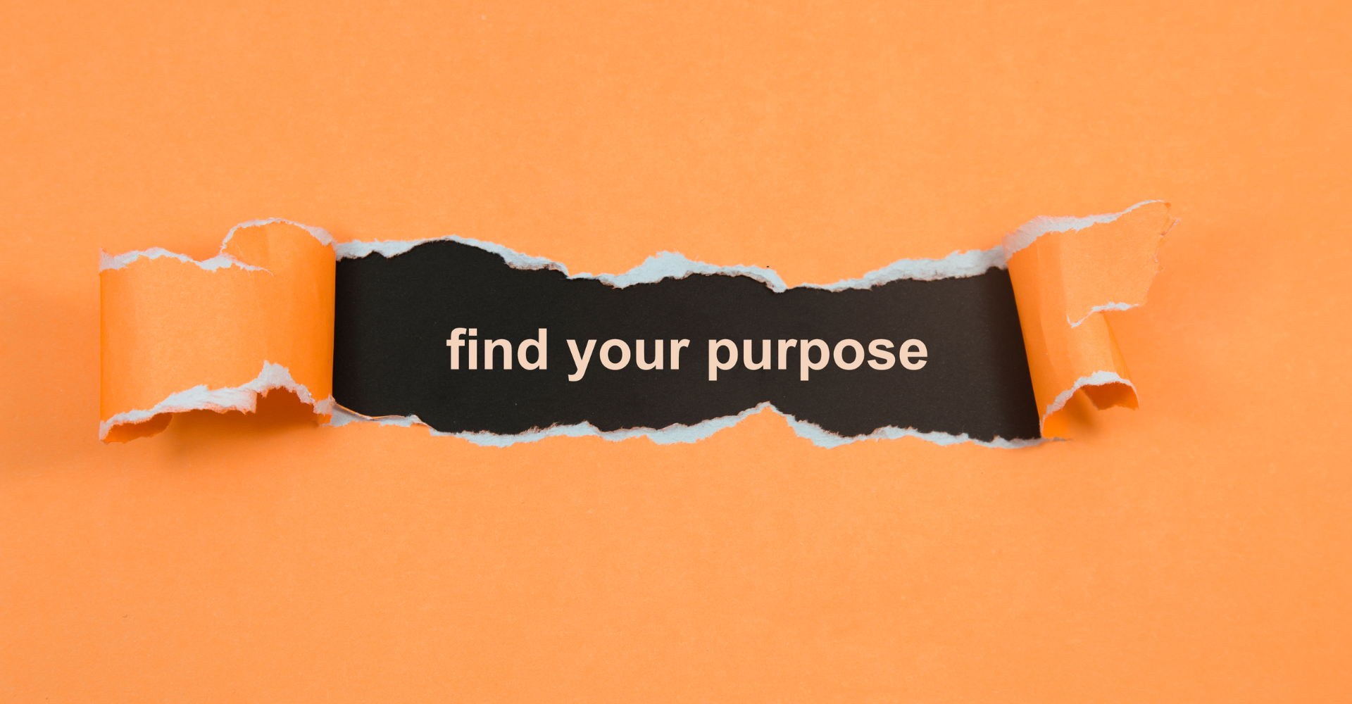 Torn orange paper reveals the phrase 