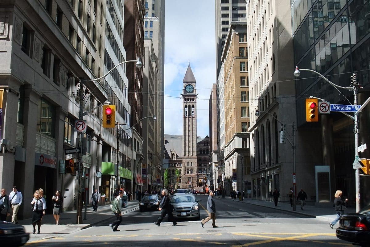Street view of high-rise commercial buildings along Bay Street corridor in downtown Toronto.