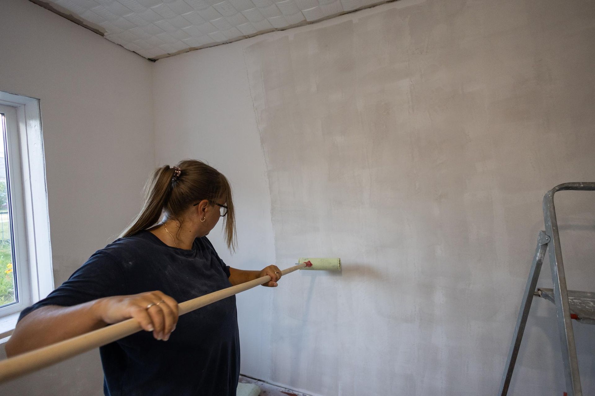 Apply glue to a wall with a roller
