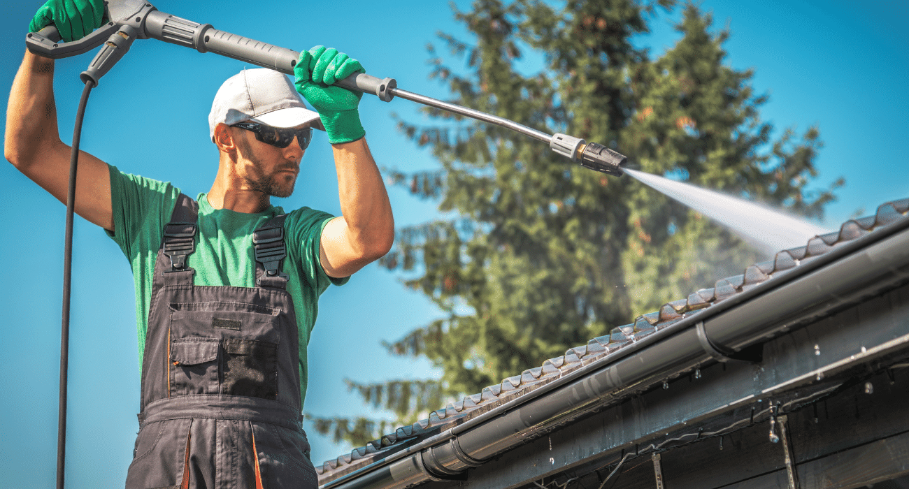 Workman wash a roof