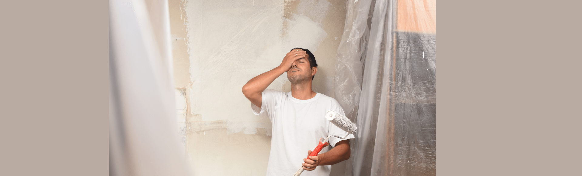 Man stressed by doing his own painting