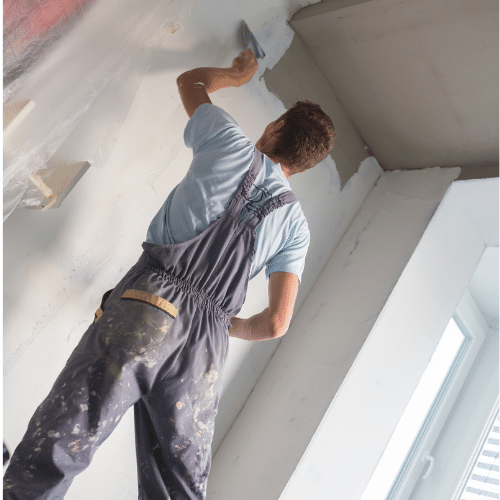 A Professional Painter cutting in near a ceiling