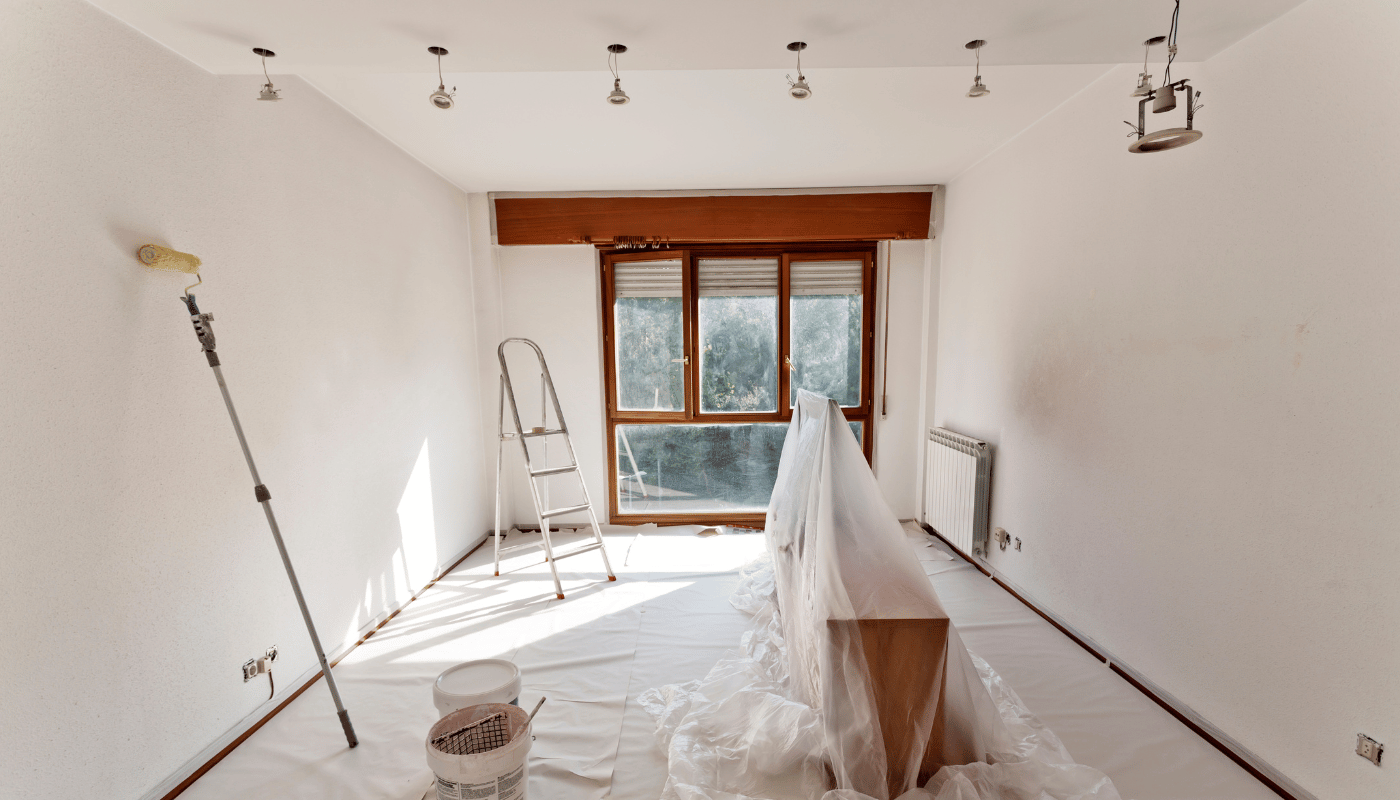 A room is being painted with a roller and ladder.