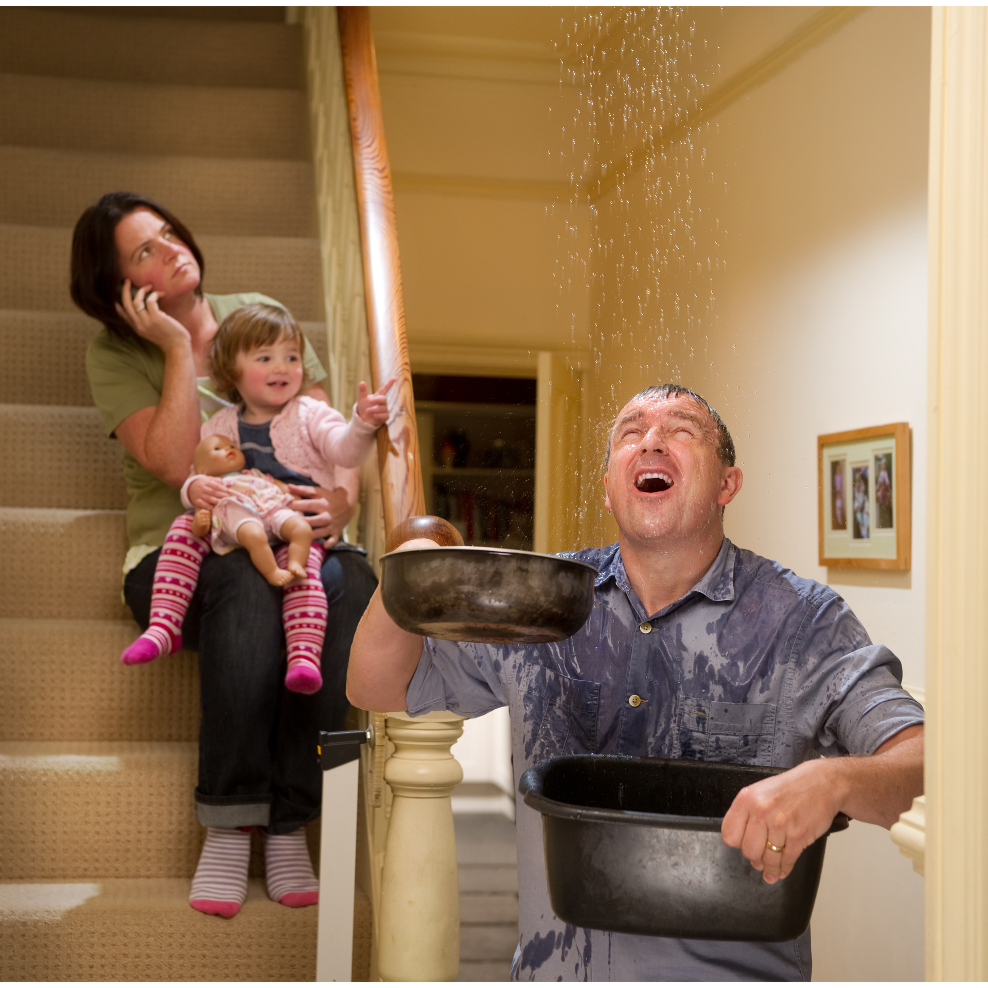 two people in a room with a leaking roof