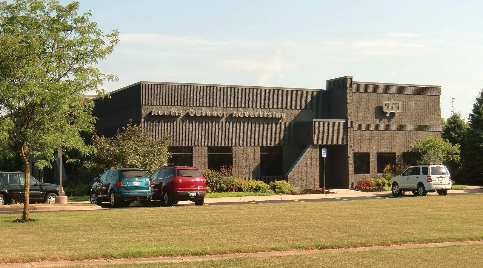 A brick building with cars parked in front of it