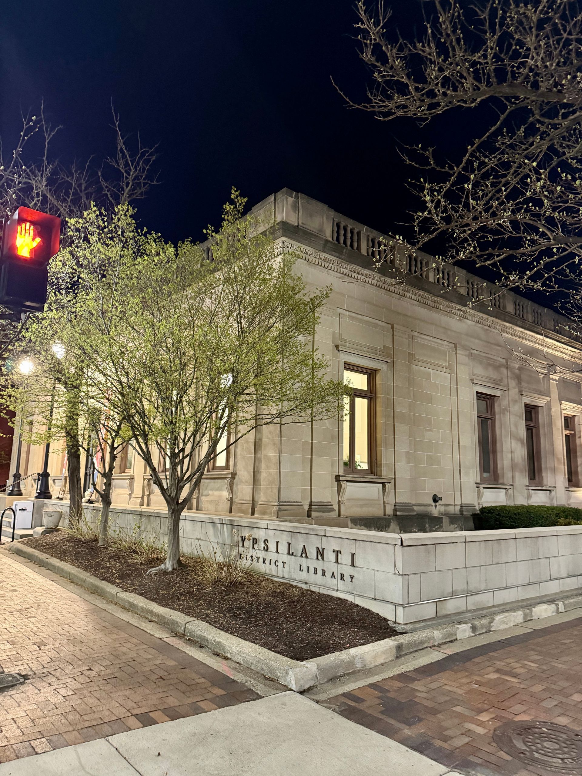 A building with a sign that says resilient is lit up at night.