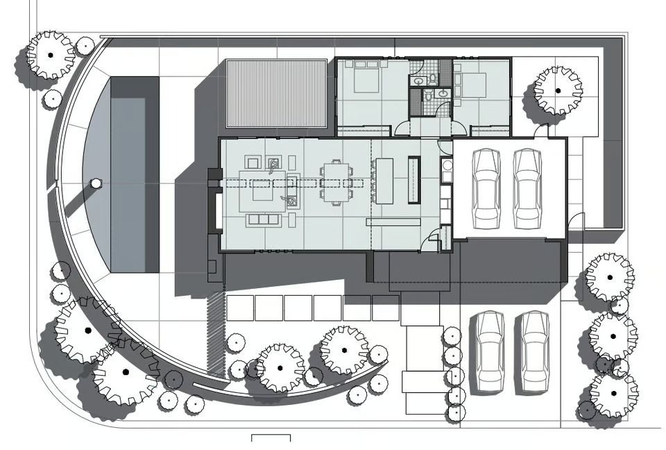 Floor plan of a modern house showing a rectangular layout, central living areas, garage, and a curved patio with trees.