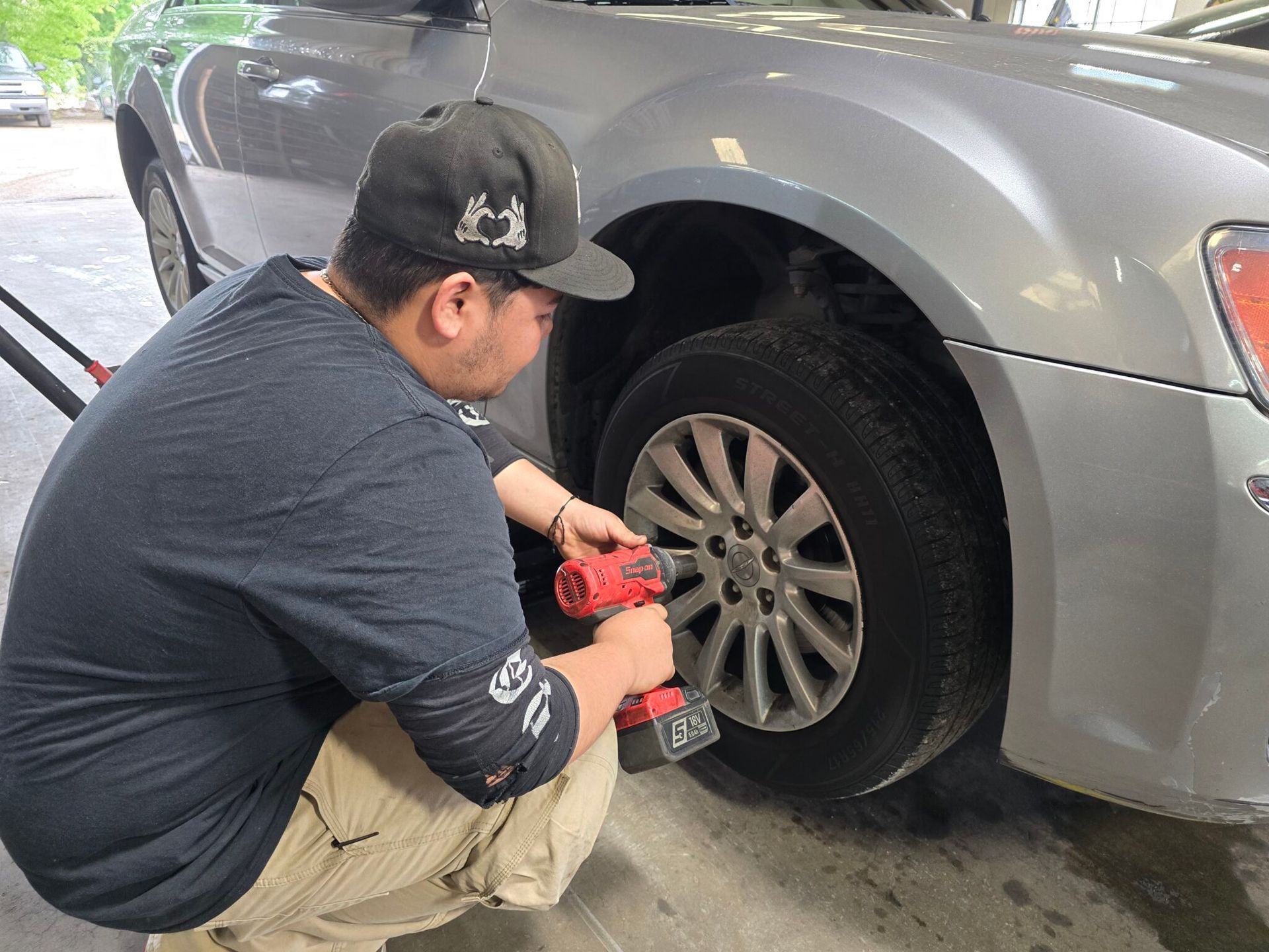 Technician Removing Tire from Vehicle | Advanced Tire & Auto Service