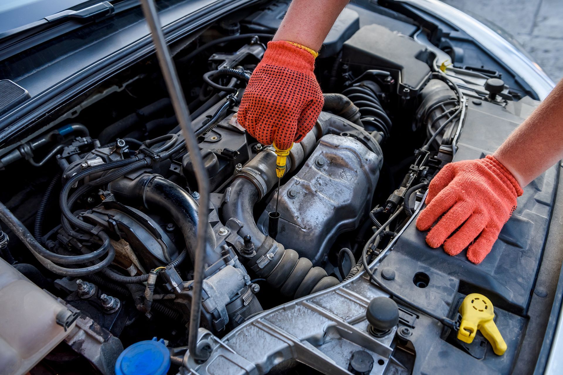 A person is working on the engine of a car.