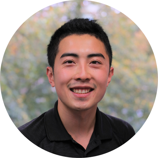 A man in a black shirt is smiling in a circle