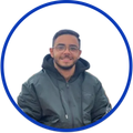 Smiling person in a dark jacket inside a blue circular frame on a white background