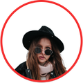 Portrait of a person in a black hat and round sunglasses, framed by a red circle