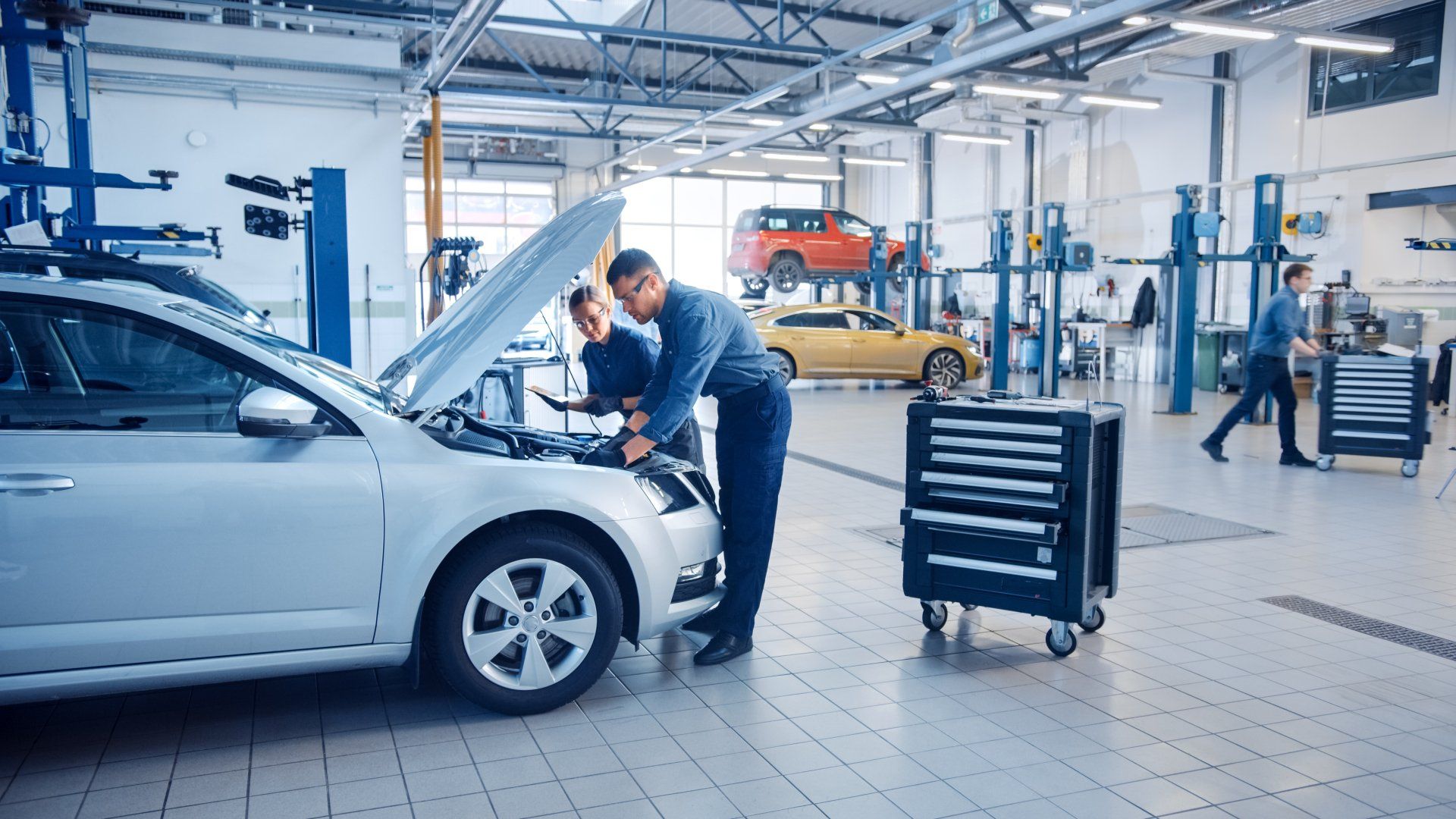 Two Mechanics Inspecting a Car