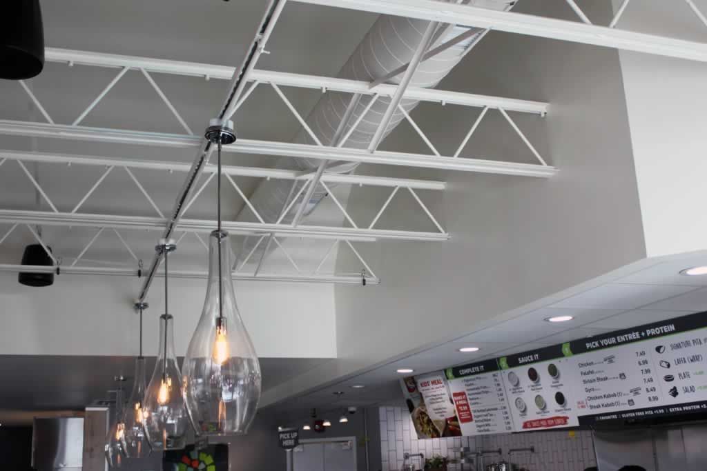 The ceiling of a restaurant with a menu on the wall.