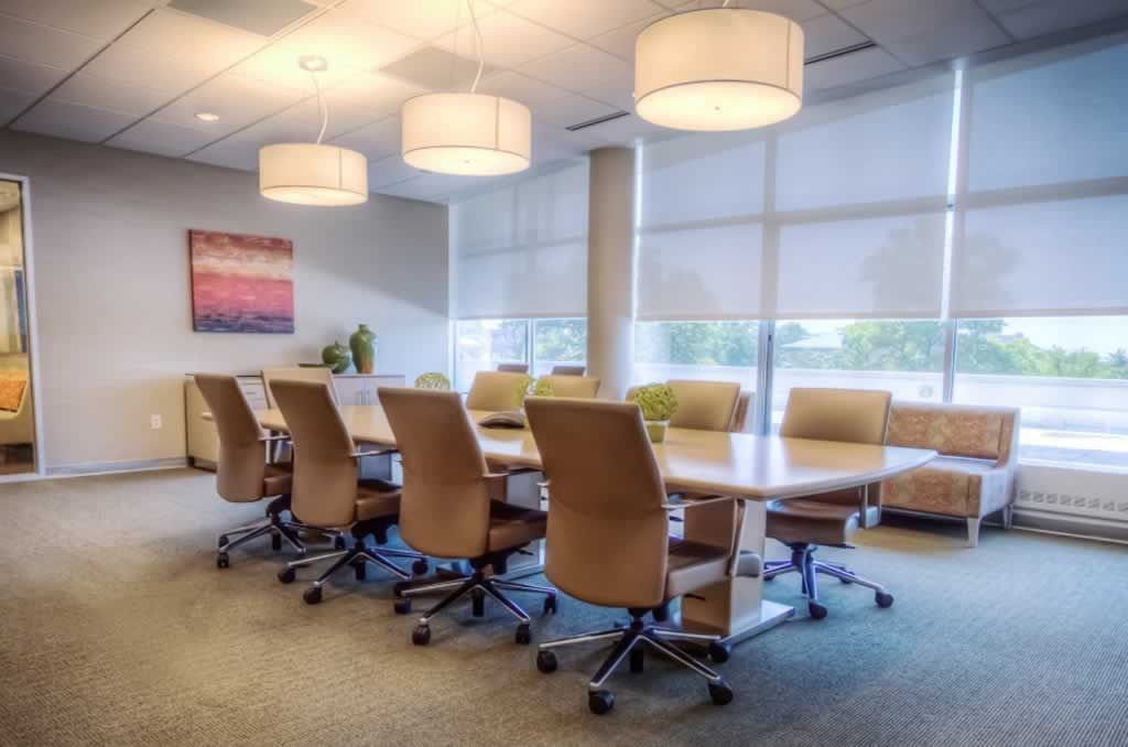 A conference room with a long table and chairs.