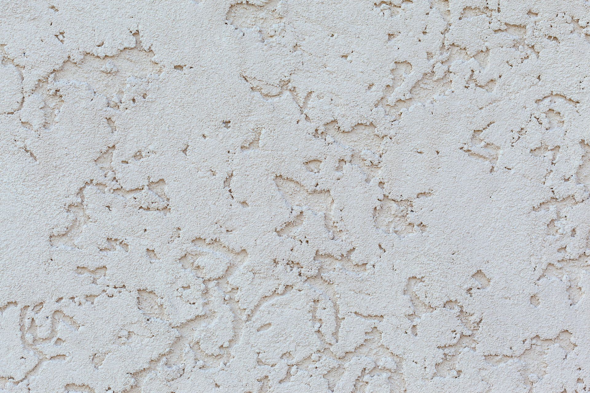 Textured stucco wall, off-white with irregular patterns.