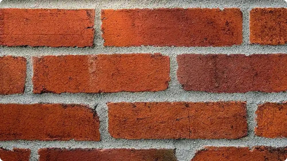 Red brick wall with gray mortar.