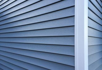 A close up of a blue siding on a house