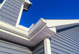 The corner of a house with a blue sky in the background