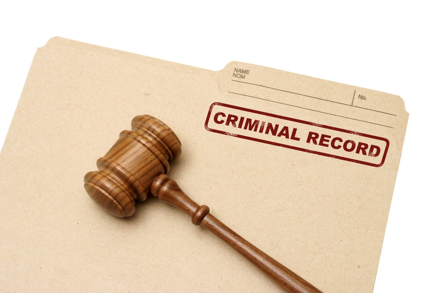 A wooden gavel rests on a file folder stamped with 