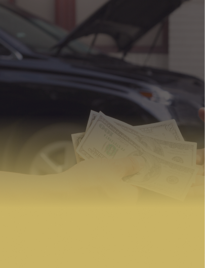 A person is holding a pile of money in front of a car. | Birch's Automotive