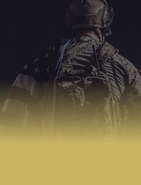 A soldier is holding an american flag on his back. | Birch's Automotive