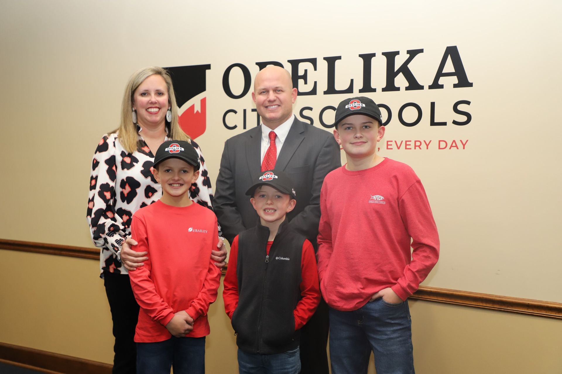 Coach Bryan Moore and his Family. Photo from Opelika City Schools Facebook Page.