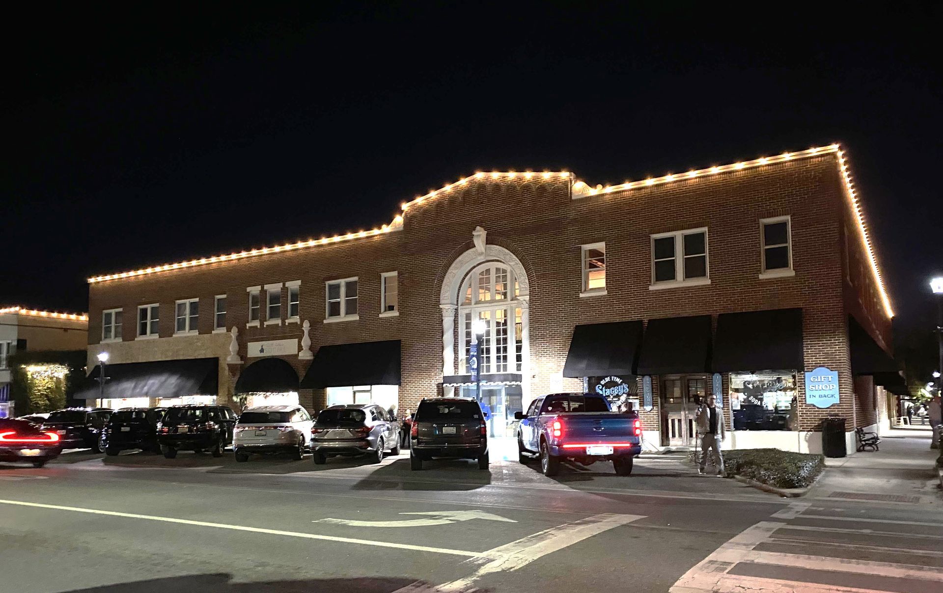 The outline of Foley downtown buildings are lit by strings of lights provided by the city. The city is expanding the program with additional lights.