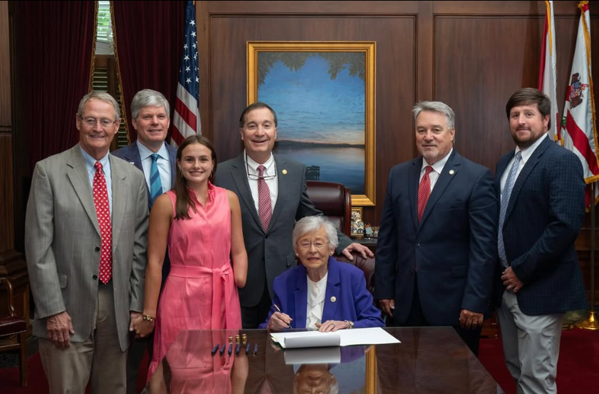 Governor Kay Ivey signing the Lulu Gribbin Shark Alert System Act, commonly referred to as “Lulu's Law.”