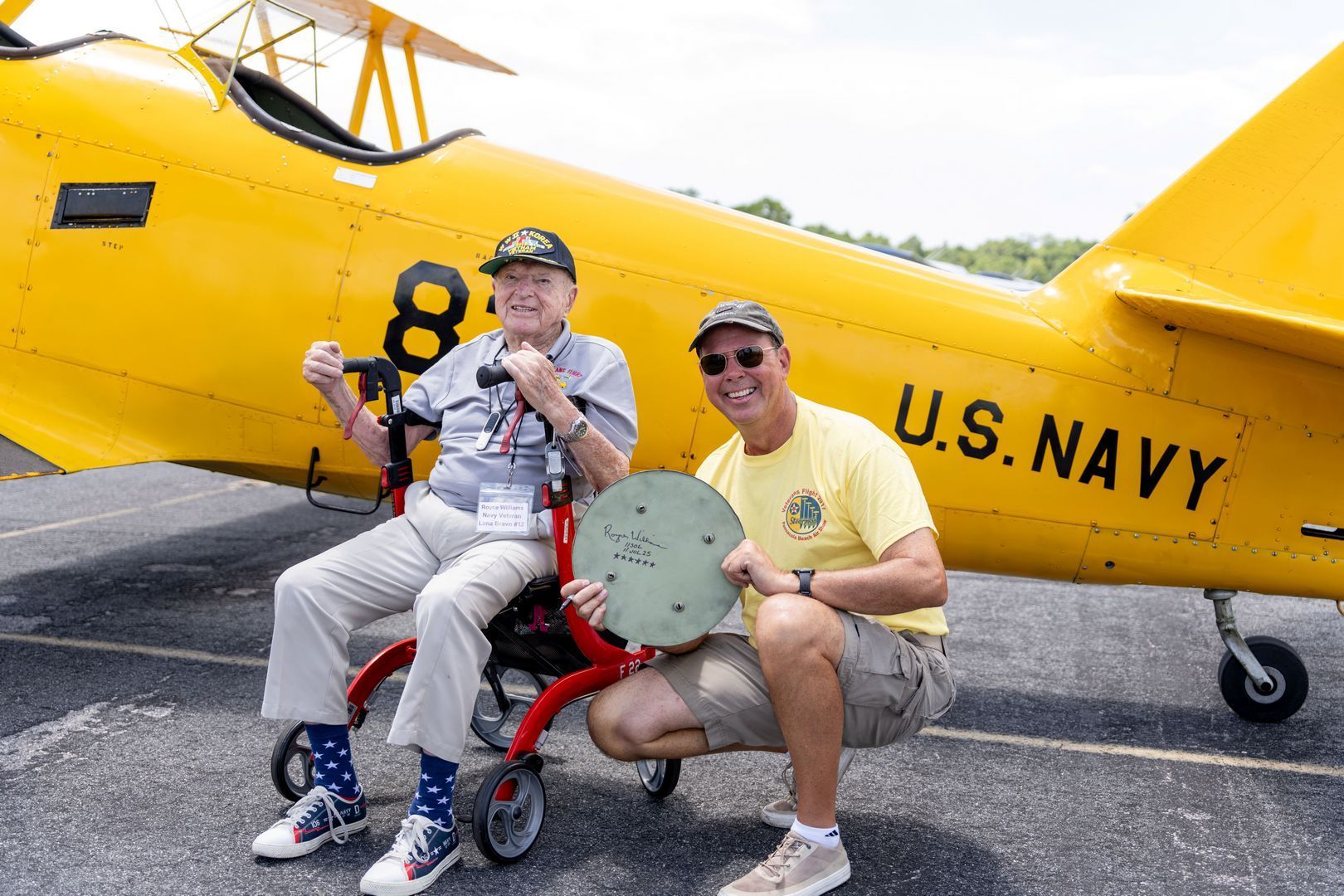 Navy Capt. Royce Williams signed a hubcap from Foley’s N3N biplane after being flown in the historic aircraft by pilot Phil Webb. Williams will receive the Medal of Honor for action in the Korean War. 