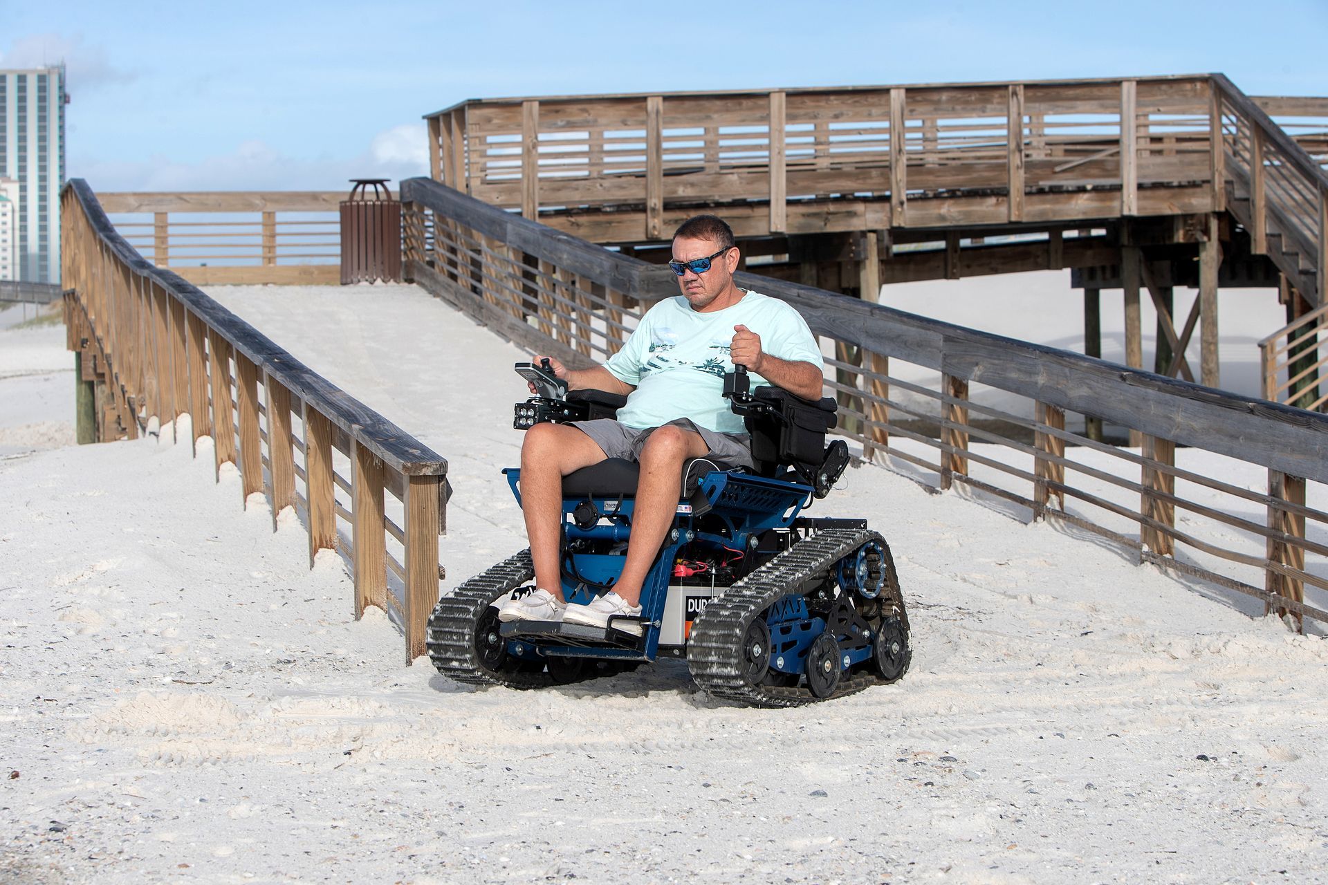 Joey Blackburn, Action Trackchairs' regional dealer, demonstrates the track chair's capabilities in the sand at Gulf State Park. Photo by Billy Pope