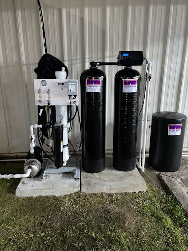 A water treatment system is sitting outside of a building.